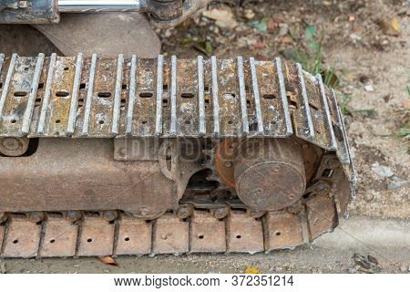 Excavator Tracks. Old Iron Caterpillars Of The Bulldozer Of The Tractor On The Road. Bulldozer Cater