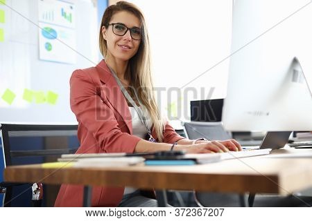 Portrait Of Lovely Lady Working On Modern Computer In Office. Beautiful Young Woman In Personal Cabi
