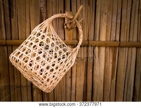 Bamboo Basket Weaving Handmade, It Is Hung On An Old Looking Bamboo Fence.lopburi,thailand
