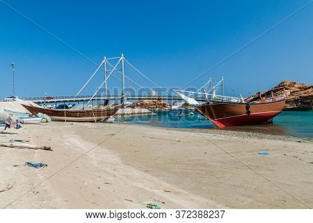 Traditional Dhow Boat Yards In Sur, Oman. Khor Al Batar Bridge In The Background.