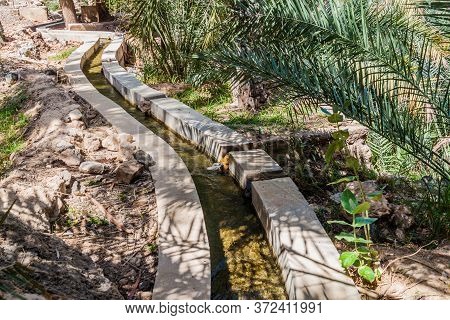 Traditional Irrigation Canal Called Falaj In Wadi Tiwi Valley, Oman