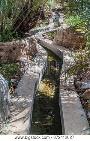 Traditional Irrigation Canal Called Falaj In Wadi Tiwi Valley, Oman