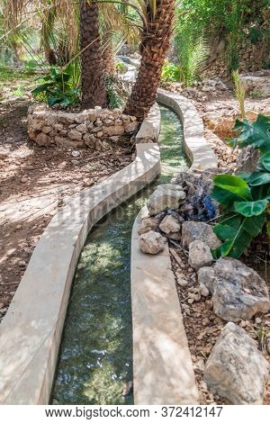 Traditional Irrigation Canal Called Falaj In Wadi Tiwi Valley, Oman