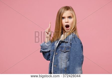 Shocked Little Kid Girl 12-13 Years Old In Denim Jacket Isolated On Pastel Pink Background In Studio