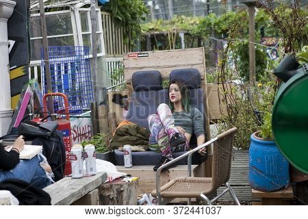 London, Uk - 17 July 2019, Nomadic Community Garden. Communal Garden Party. The Girl Is Sitting In A