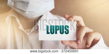 Doctors Hand Shows The Card With Word Lupus. Medical Concept