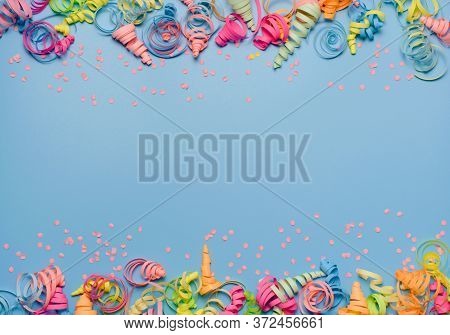 Party Background With Colorful Streamers For Celebrating Birthday. Space With Scattered Confetti. Co