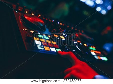 Producer  Dj Mixer In A Nightclub With Glowing Plays Musical Rave Dubstep Electronic Trance Composit