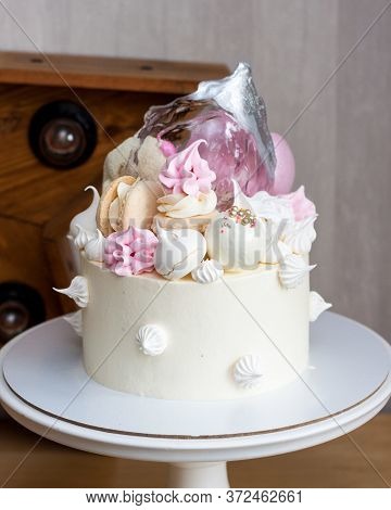 Elegant White Cake With Isomalt, Chocolate, Macaroons, Meringues, Pink And Silver Elements.