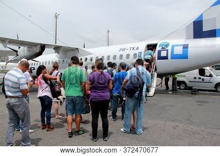 Salvador, Bahia / Brazil - October 19, 2012: Passengers Are Seen During Boarding The Atr-72 Aircraft