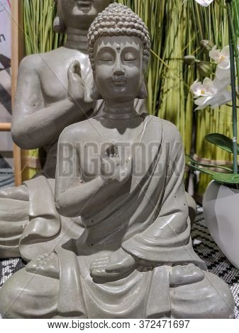 A Grey Statue Of Buddha. High Quality Photo