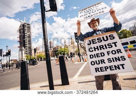 London / Uk - 06/20/2020: Street Preacher Outside The British Parliament Stating Jeus Christ Will Re