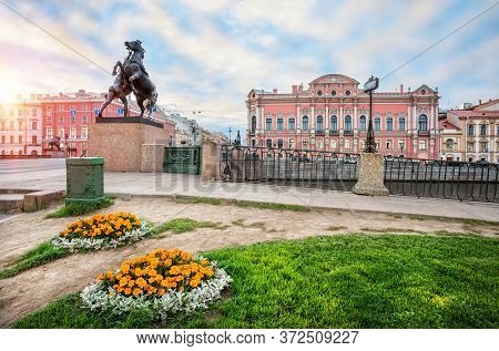 Anichkov Bridge And Palace In St. Petersburg. Sculptures Of Klodt's Horses And Flower Beds On A Summ