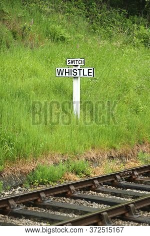 Whistle Railway Sign.  The View Across Railway Track Towards A Sign Requiring Oncoming Trains To Blo