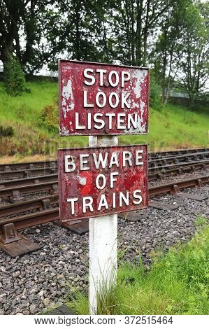 Stop Look Listen Railway Sign.  A Sign Warning Pedestrians To Stop, Look And Listen And Beware Of On