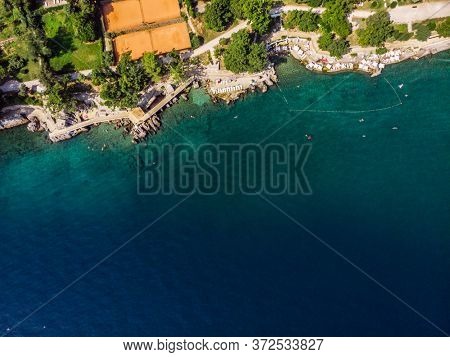 Beautiful panoramic view of Lovran village and its sea shore in Croatia. Top view photo taken on drone.