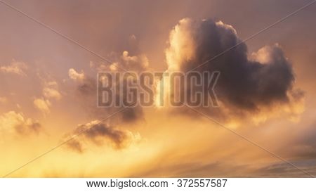 Beautiful Summer Sunset Sky With Heart Shaped Cloud And Colorful Vibrant Clouds And Sun Beams Across