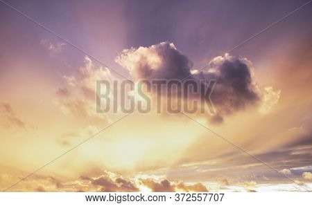 Beautiful Summer Sunset Sky With Colorful Vibrant Clouds And Sun Beams Across Whole Sky