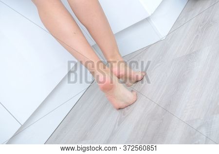 Woman's Feet On The Floor
