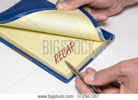 Notebook With A Pen And The Word Recap. Recap Concept