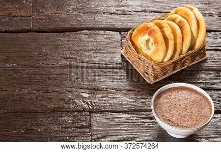 Pandequeso Traditional Colombian Food - Hot Drink Chocolate. Wood Background
