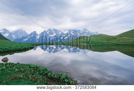 Mountain Lakes Of Koruldi. Caucasian Mountains. The Peaks Of The Snowy Mountains Are Reflected In Th