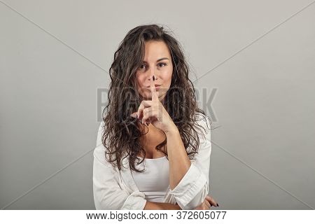 Index Finger On Lips, Silence Gesture, Shhh Quiet, Asks For Voicelessness Forefinger At The Mouth. Y