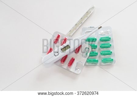 Mercury And Digital Thermometers About Red And Green Pills