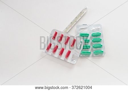 Mercury Thermometer About Green And Red Pills