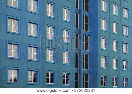 Facade Of Office Blue Building With Windows. Facade Of An Old Blue Brick Wall With Windows. Old Blue