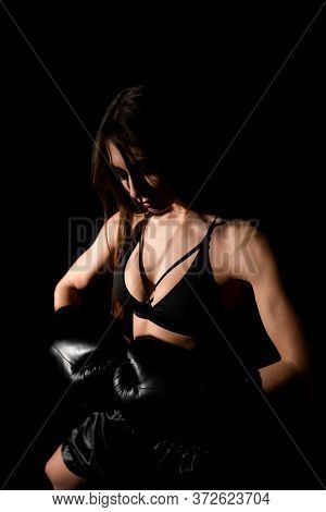 Female Boxer Training In The Dark Ring. Silhouette. Boxing Concept. Fighter Woman Fist Close Up. Sex