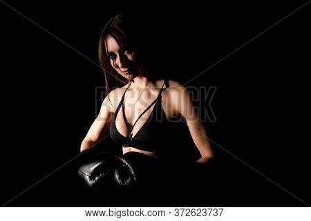 Female Boxer Training In The Dark Ring. Silhouette. Boxing Concept. Fighter Woman Fist Close Up. Sex