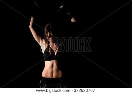 Female Boxer Training In The Dark Ring. Silhouette. Boxing Concept. Fighter Woman Fist Close Up. Sex
