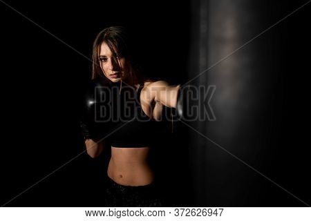 Female Boxer Training In The Dark Ring. Silhouette. Boxing Concept. Fighter Woman. Sexy Girl With Pe