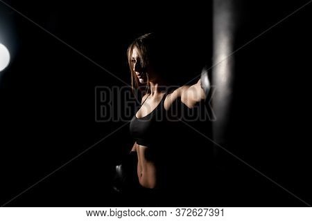 Female Boxer Training In The Dark Ring. Silhouette. Boxing Concept. Fighter Woman Fist Close Up. Sex