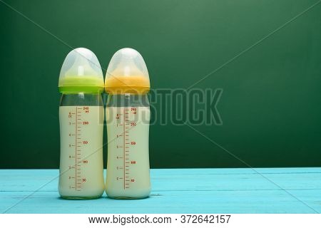 Two Glass Baby Bottles With Powdered Milk With Copy Space