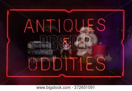 Oddities And Antiques Neon Sign In Shop Window