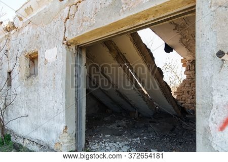 The Wall With The Doorway In The Ruins Of The Collapse Of The Devastation. Danger Of Collapse.