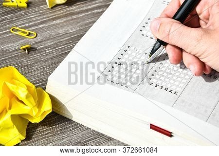 Student Hand With Pencil For The Exam. Printed School Test, Home Education, Study At Home
