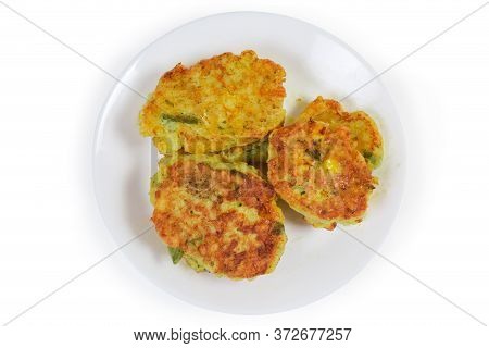 Fried Savory Rice Fritters With Vegetables On The White Dish On A White Background, Top View