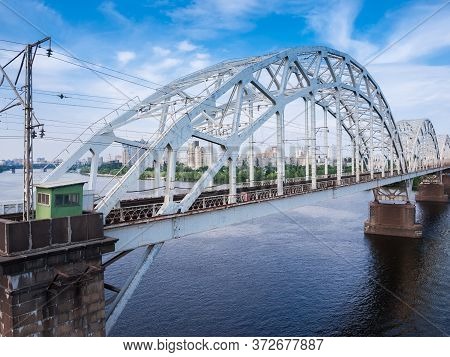 Three Spans Of The Railroad Bridge With Steel Riveted Arch Trusses Over The River. Fragment Of The D