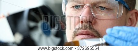 Close-up Man Goggles Mends Mechanical Part Device. Replacement Thermal Paste Processor, Lubrication 