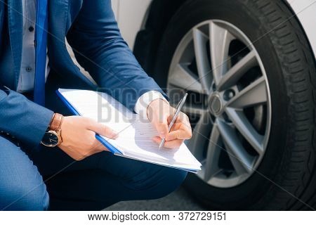A Man Writes In A Tablet Next To The Car. An Accident On The Road, The Airbag Didnt Work.