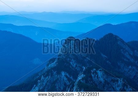 Spectacular View Of Blue Mountain Ranges Silhouettes And Fog In Valleys. Julian Alps, Triglav Nation