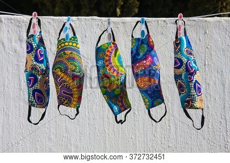 Colorful South African Fabric Face Masks For Covid-19 Protection Hanging Out To Dry On A Clothesline