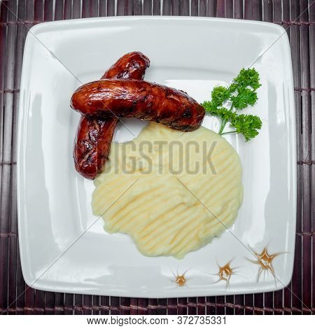 Potatoe With Sousages On The White Plate