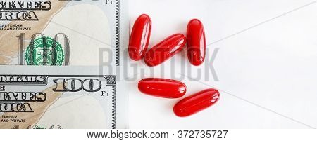 Banknote On White Background, Red Pill Capsules And Concept For Life Medicine. The Concept Of The Ec