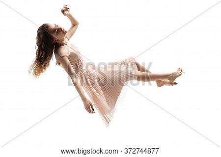 Mid-air Beauty Cought In Moment. Full Length Shot Of Attractive Young Woman Hovering In Air And Keep