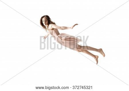 Mid-air Beauty Cought In Moment. Full Length Shot Of Attractive Young Woman Hovering In Air And Keep