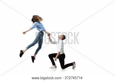 Mid-air Beauty Cought In Moment. Full Length Shot Of Attractive Young Woman And Man Hovering In Air 